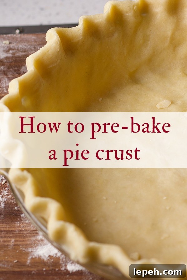 Pie dough that's been fitted into a glass pie plate and is ready to be baked.