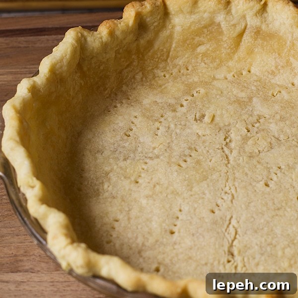 The bottom pie crust in a pie plate, ready to bake.