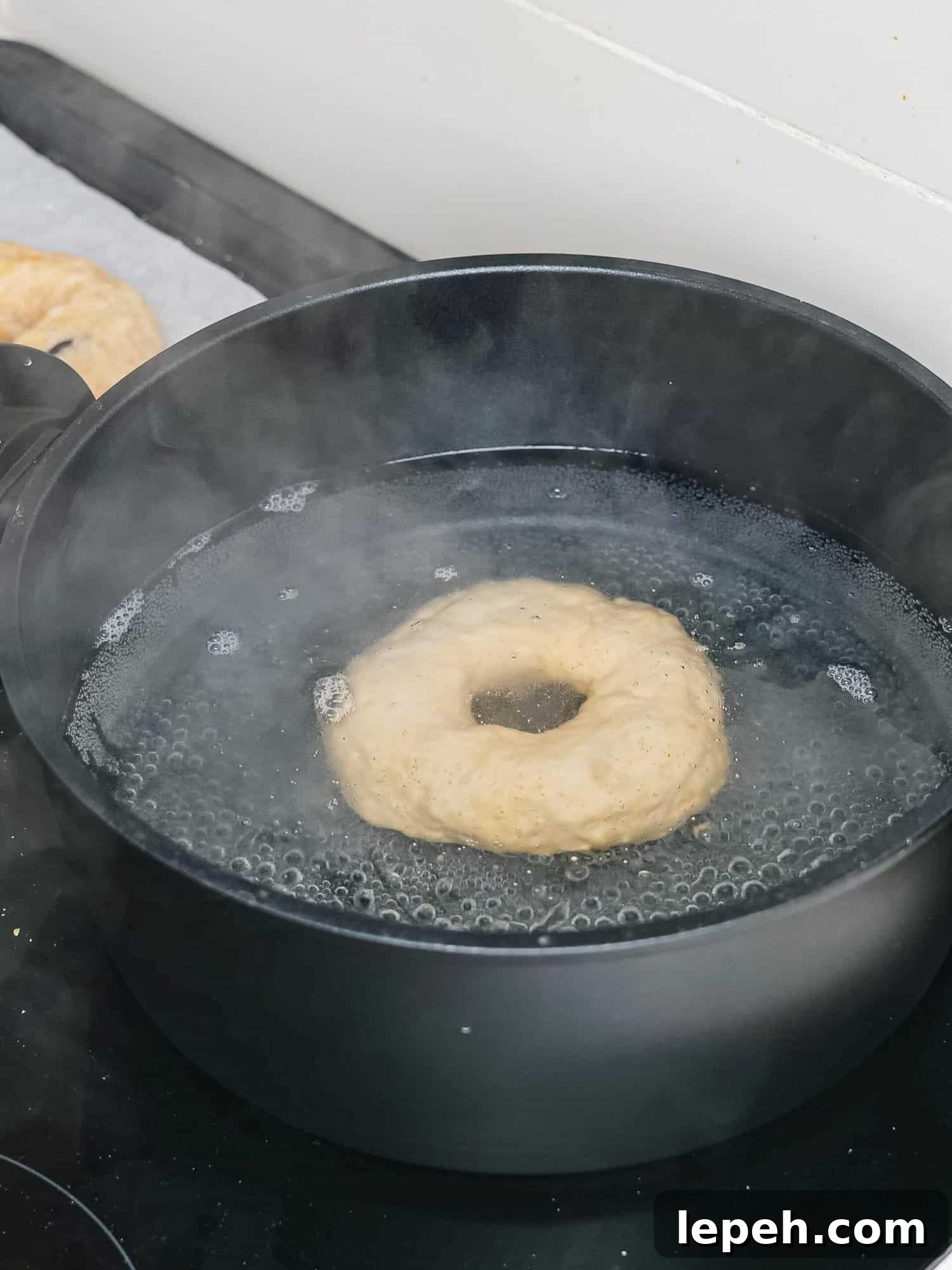 Boiling a blueberry bagel.