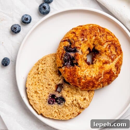 Blueberry bagel sliced in half.