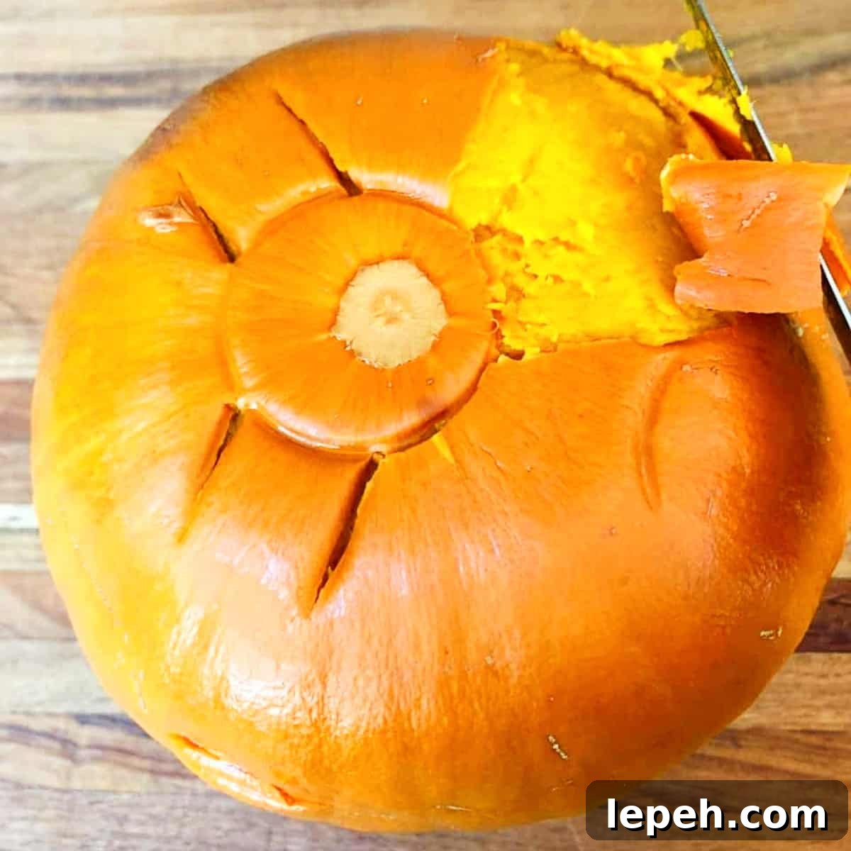 pumpkin skin being removed from a cooked pumpkin