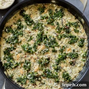 vegan white bean mushroom alfredo in the pan with spinach