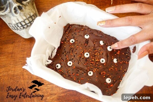 candy eyes and orange and black sprinkles on this easy dark chocolate fudge Halloween dessert recipe