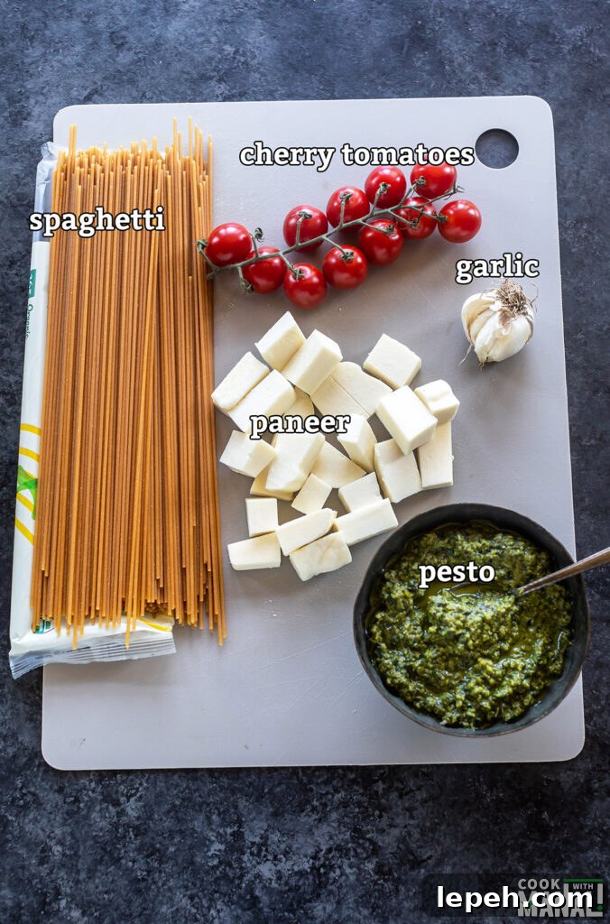 ingredients for paneer pesto pasta arranged on a board