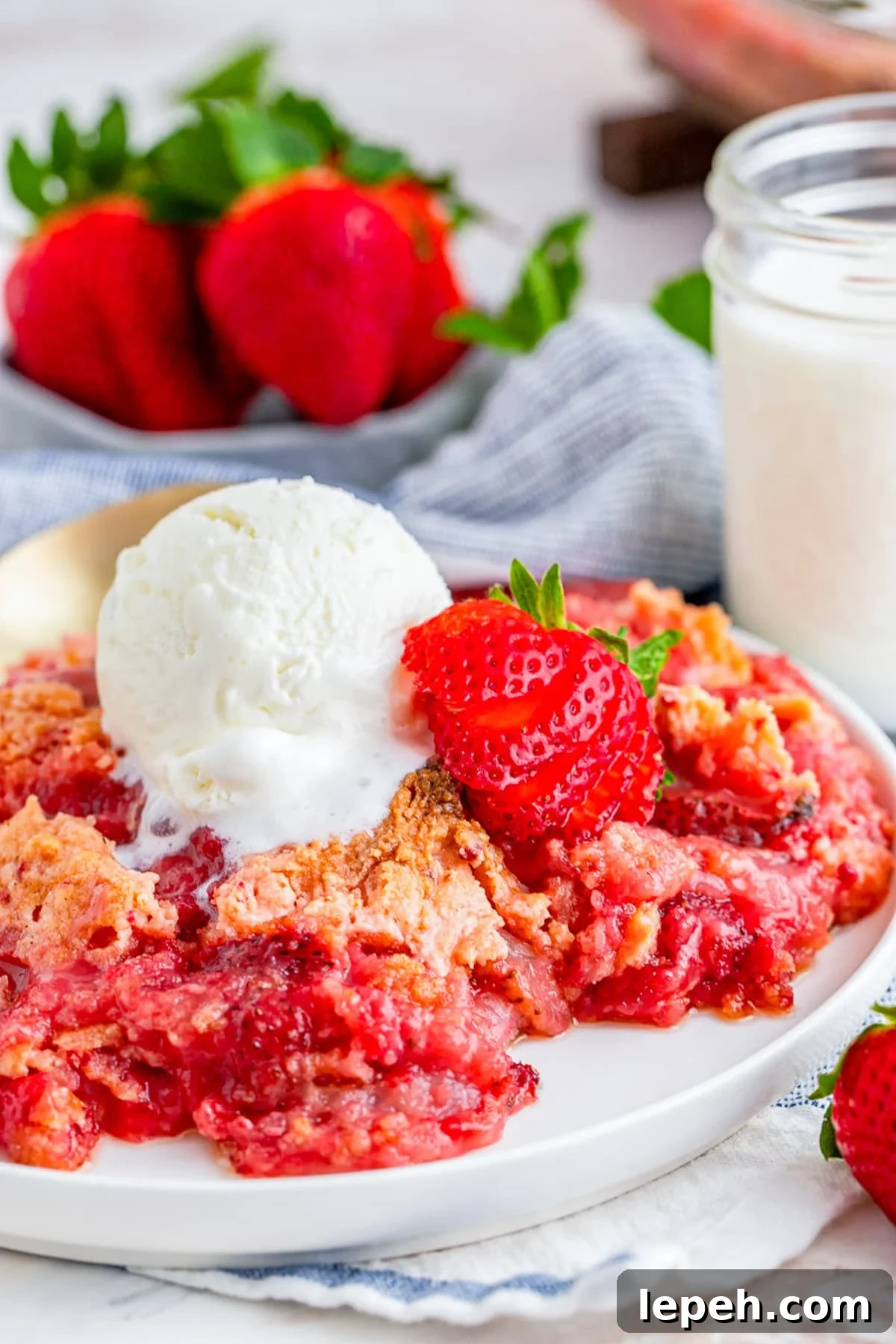 Strawberry Dump Cake served in a plate with ice cream