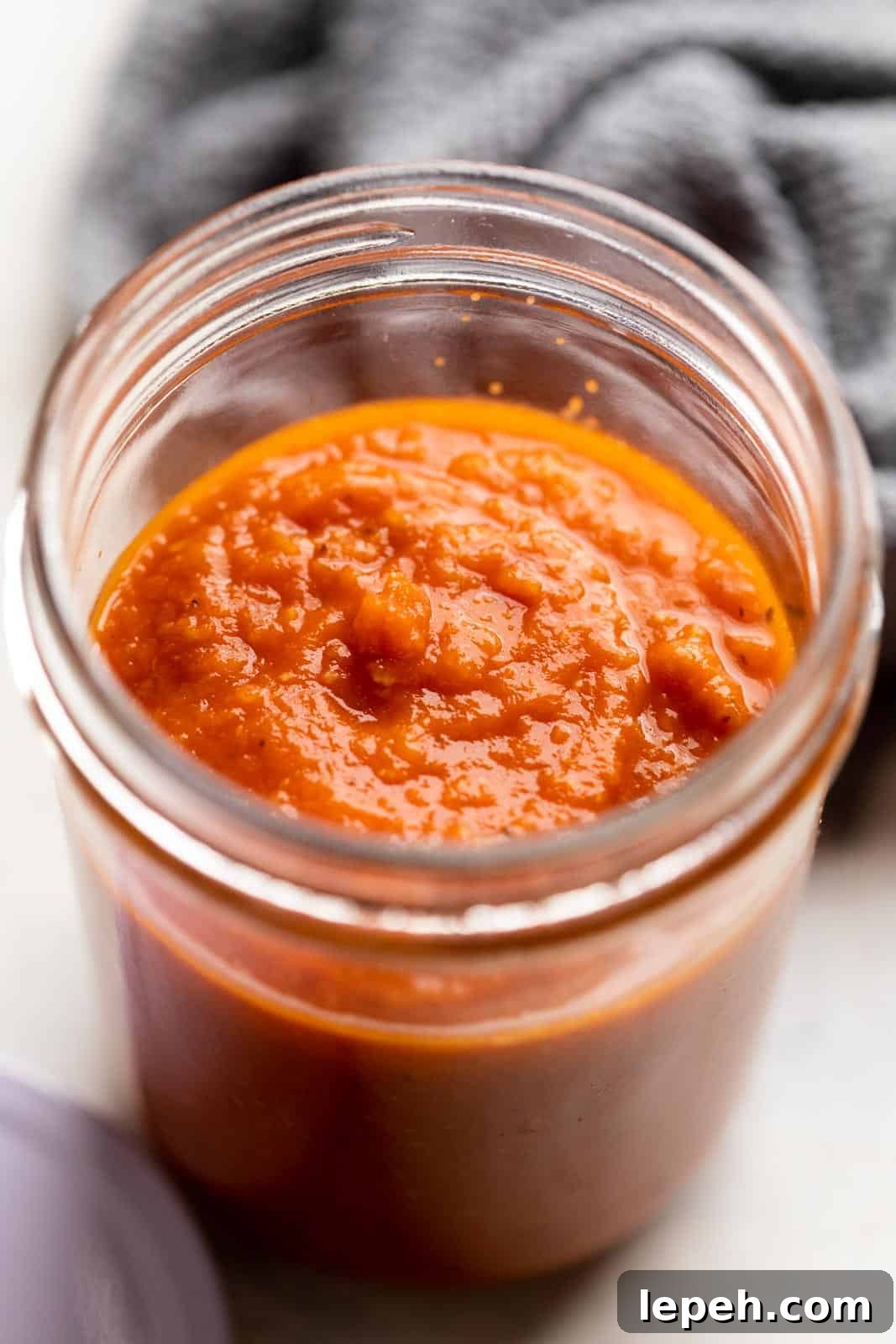 Cooked pasta sauce in a jar ready to be stored