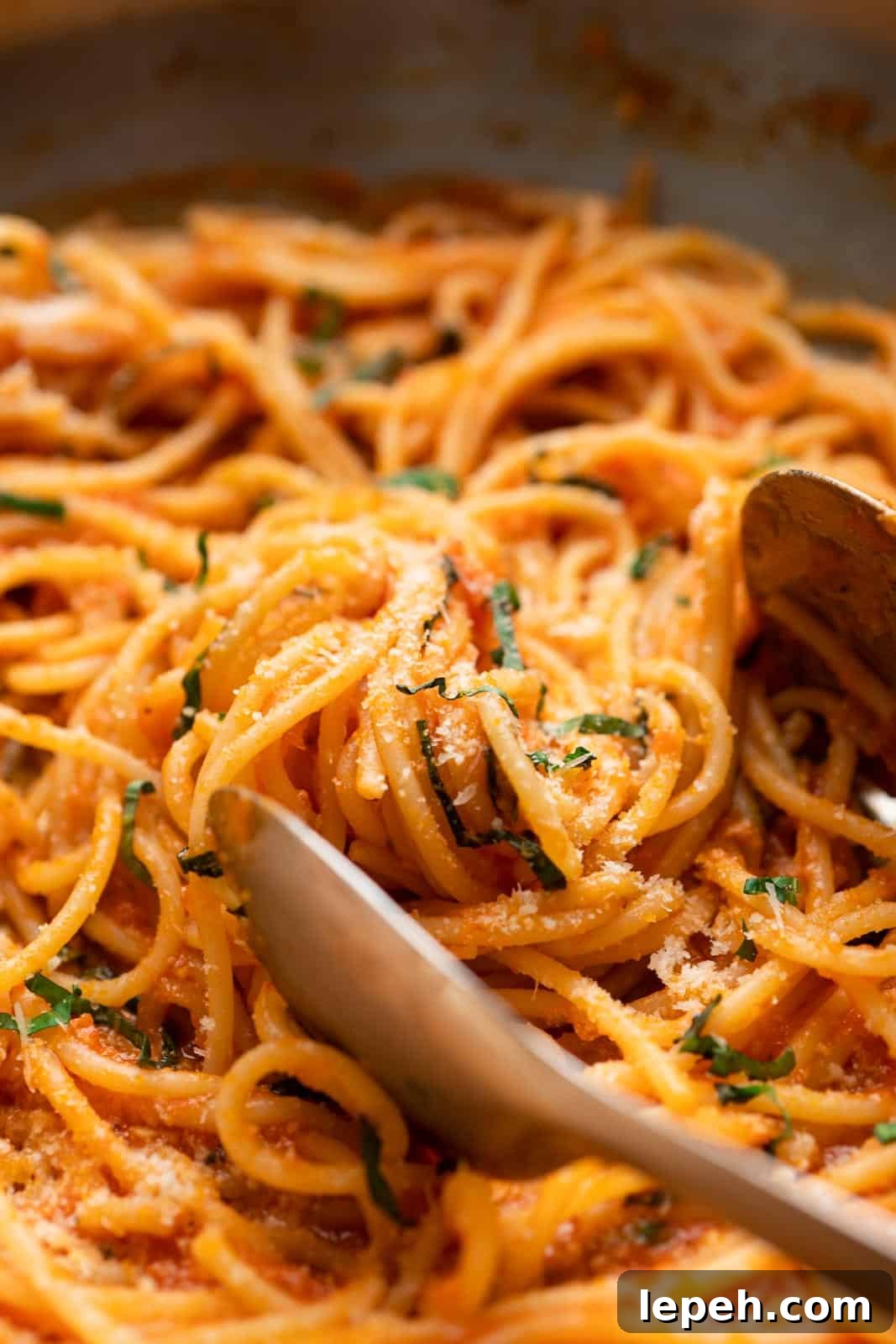 Closeup of spaghetti tossed in easy pasta sauce