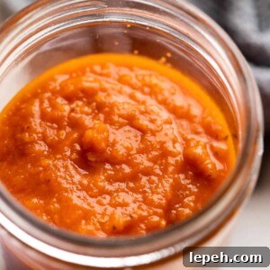 Cooked pasta sauce in a jar ready to be stored