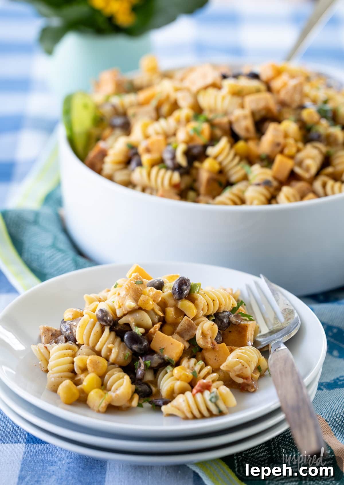 Southwest Chicken Pasta Salad in a large bowl and served on a small white plate. 