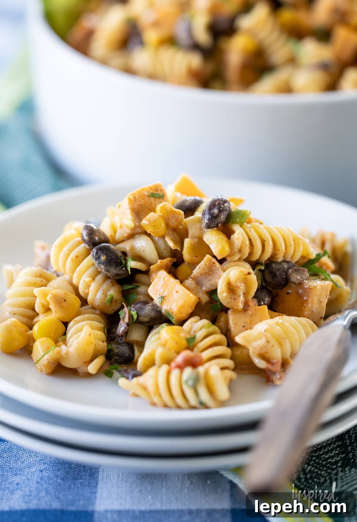 small plate filled with Southwest Chicken Pasta Salad and a fork. 