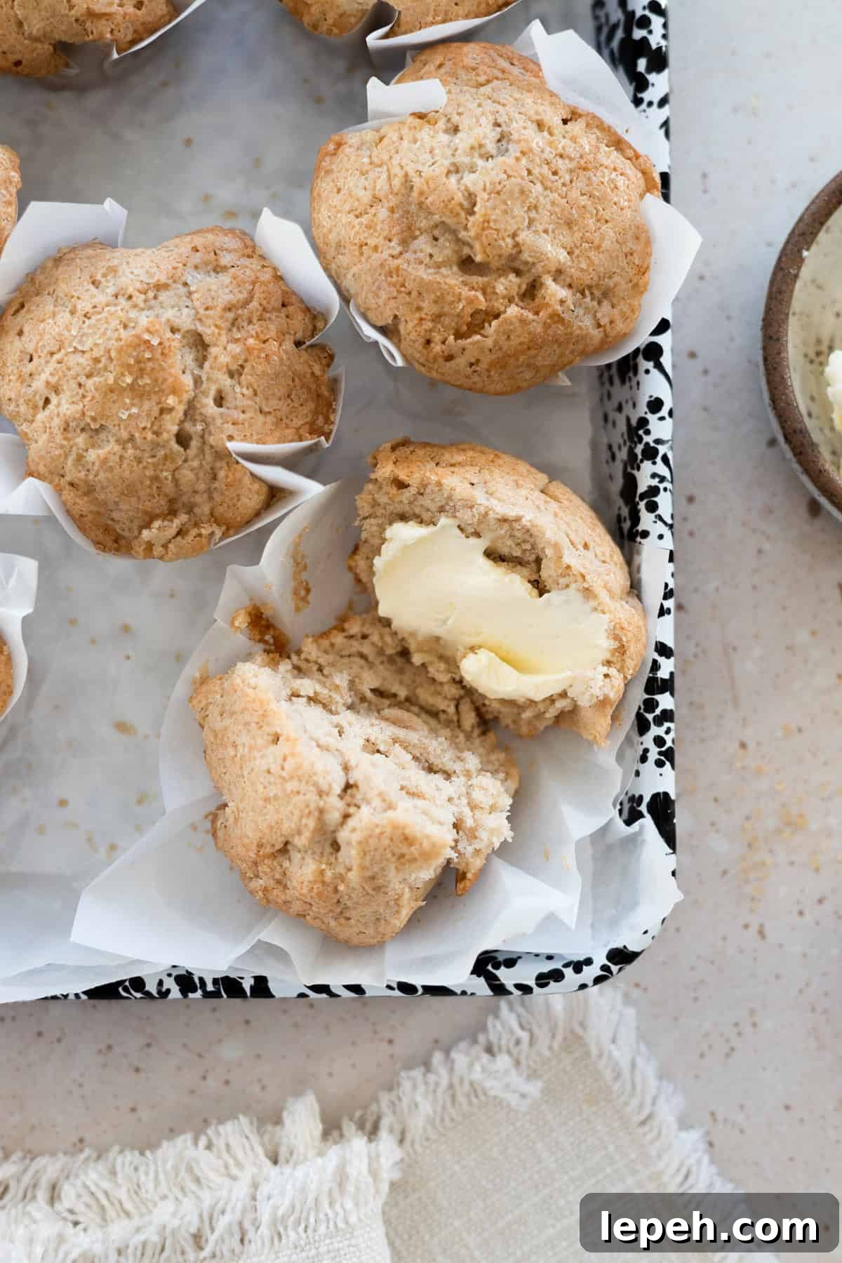 Sourdough Discard Banana Muffins on white parchment paper. 