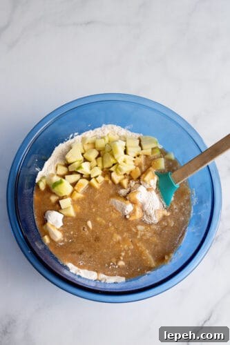 All ingredients in mixing bowl for apple pie muffins.