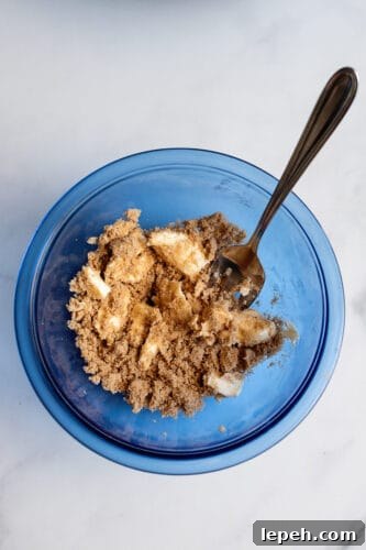 Apple pie muffins filling in mixing bowl.
