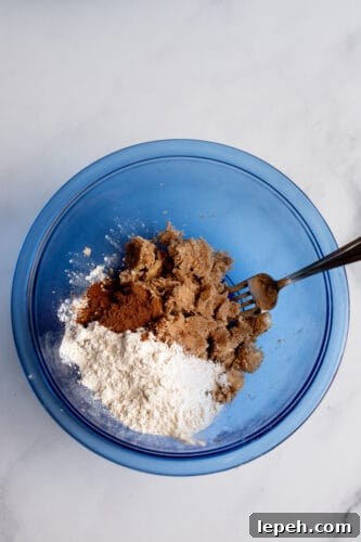 Fork with ingredients for apple pie muffins' topping.
