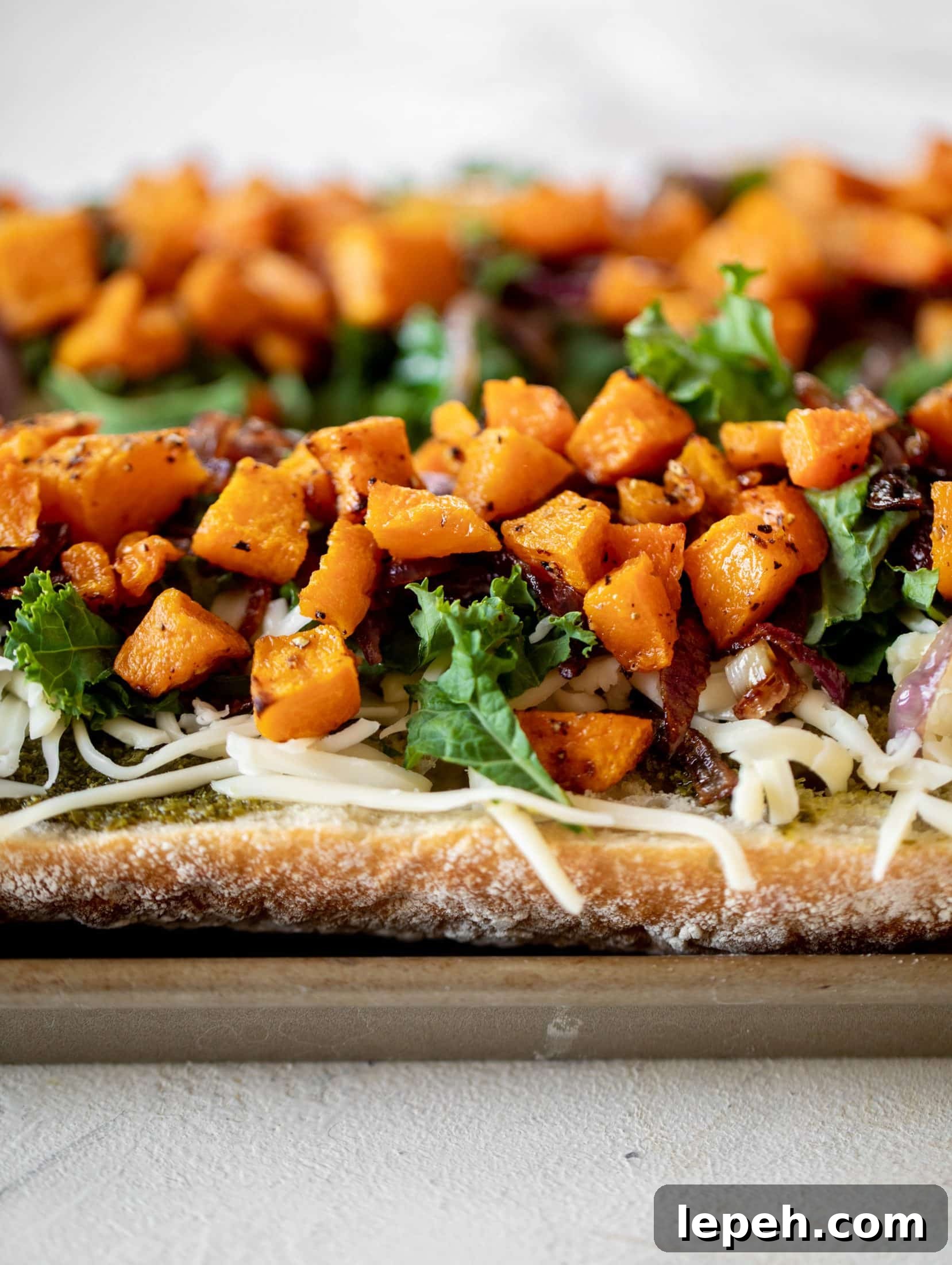 These butternut squash french breads have so much flavor. Pesto, caramelized onions, kale, roasted butternut and tons of fontina cheese. Delicious!