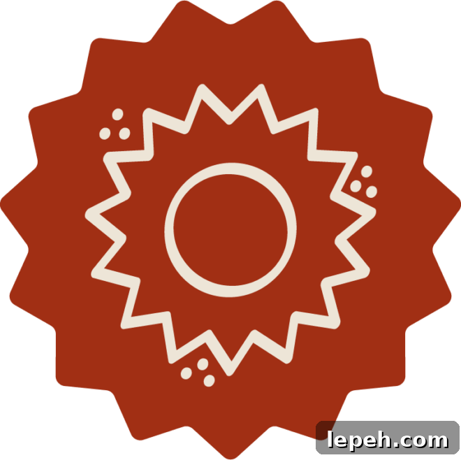 A stylized red starburst shape with a beige circular design and zigzag lines in the center, along with small beige dots on either side of the inner shape.