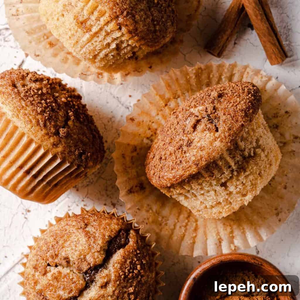 cinnamon muffins unwrapped with cinnamon on the side