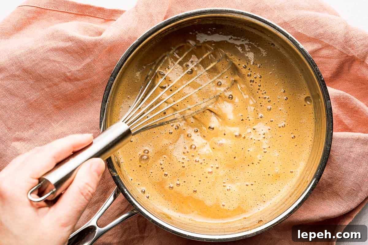 whisking finished pumpkin spice syrup in pan
