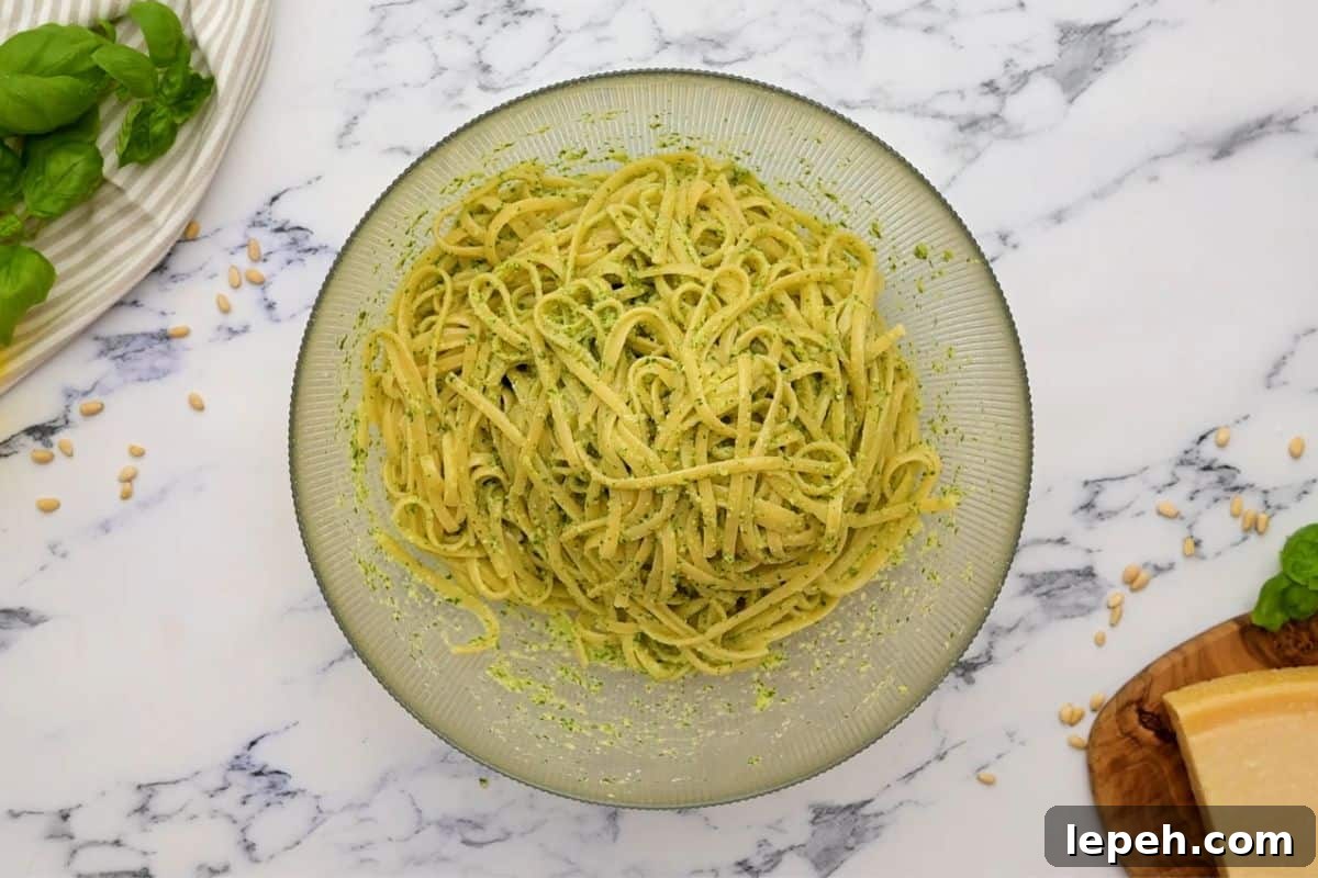 Cooked linguine noodles tossed with homemade basil pesto.