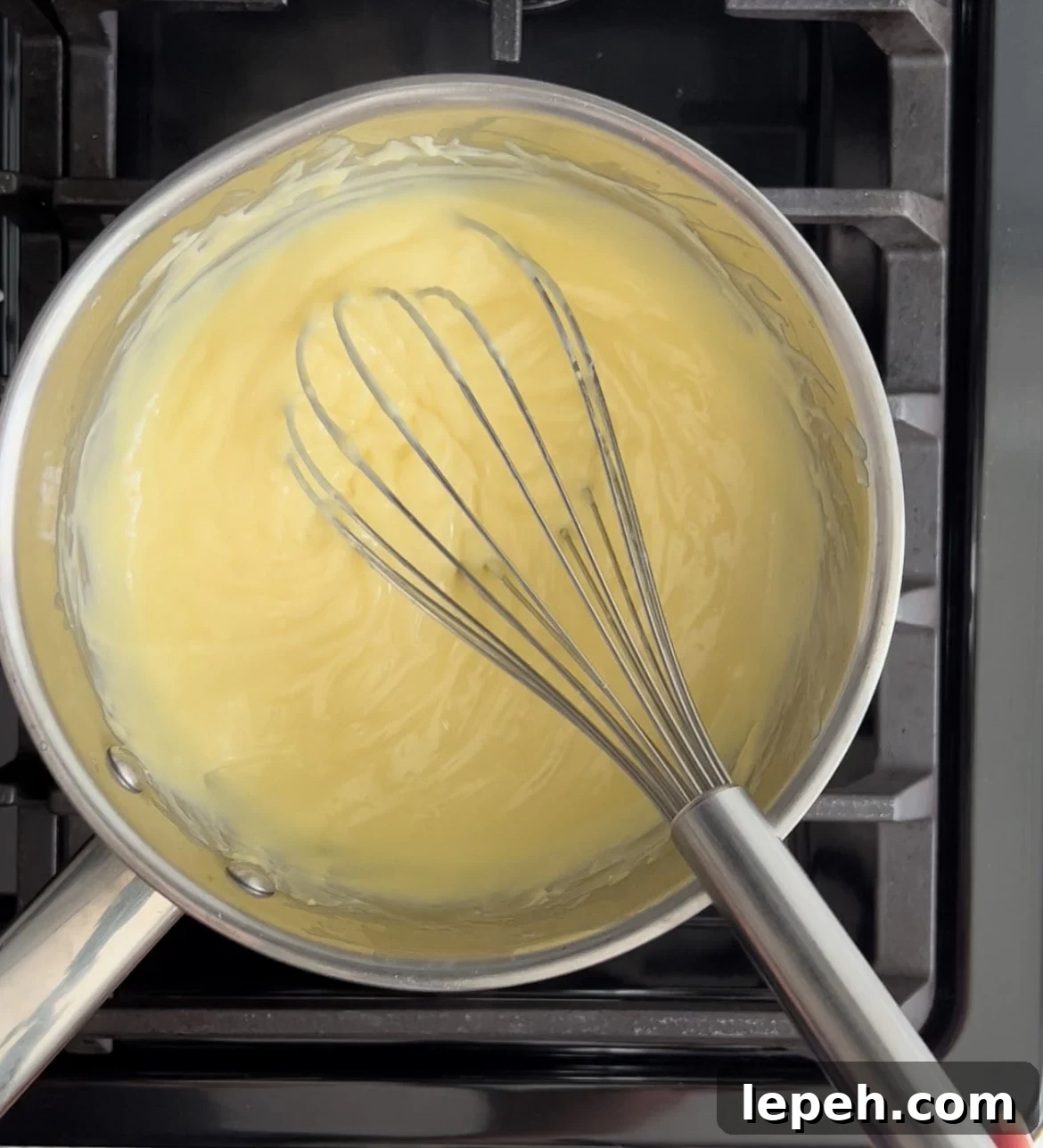 Pastry cream in a pot on the stove.