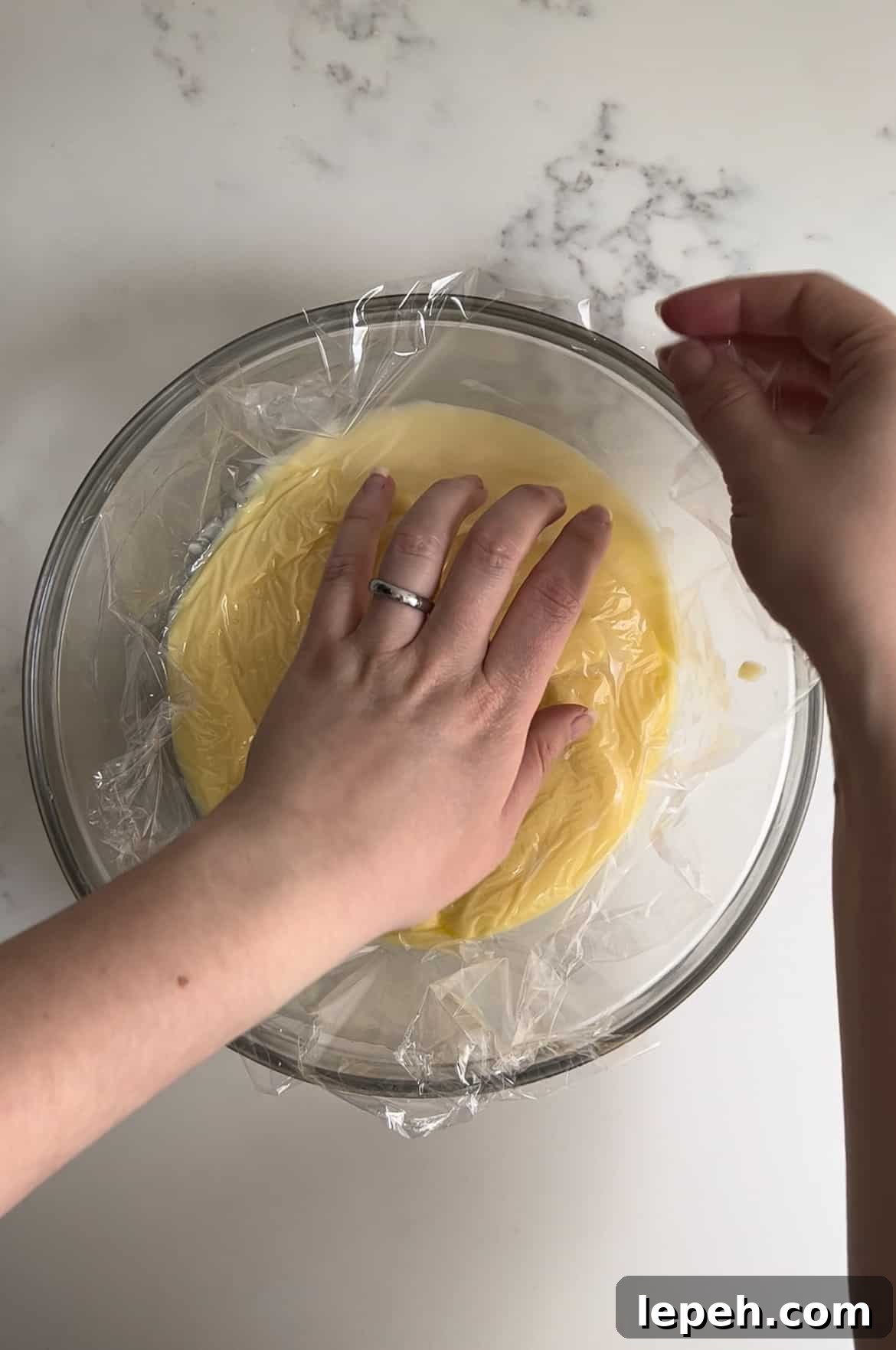 Plastic wrap on top of pastry cream.