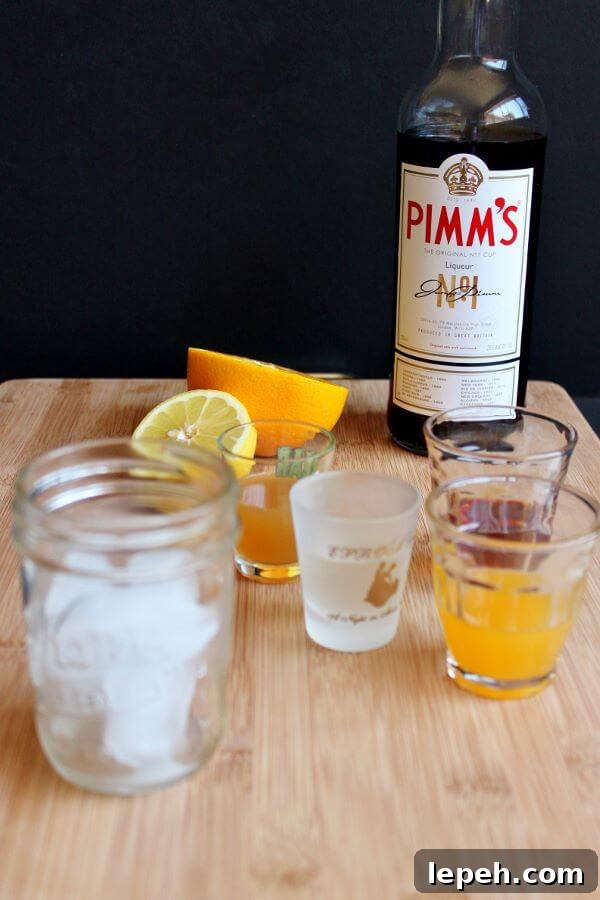 Making a Pimm's Sundowner, starting with ice in the glass.