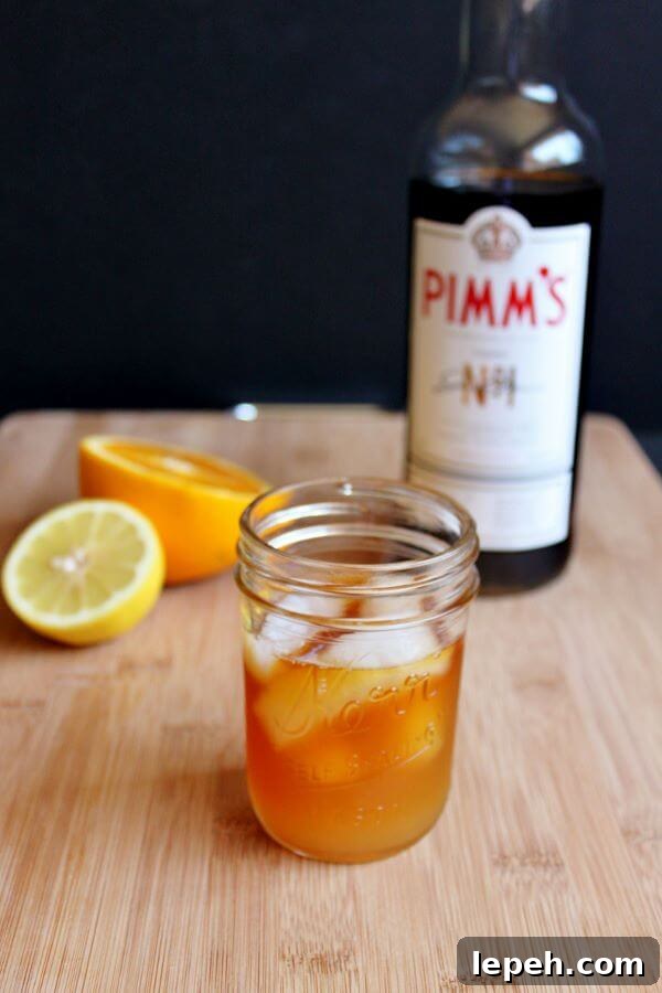 Making a Pimm's Sundowner, adding liquid ingredients.