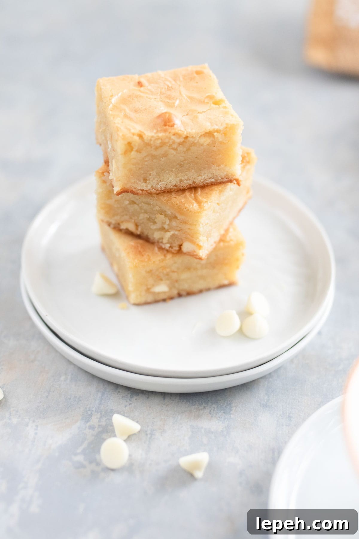 Stacked white chocolate bars on a plate.