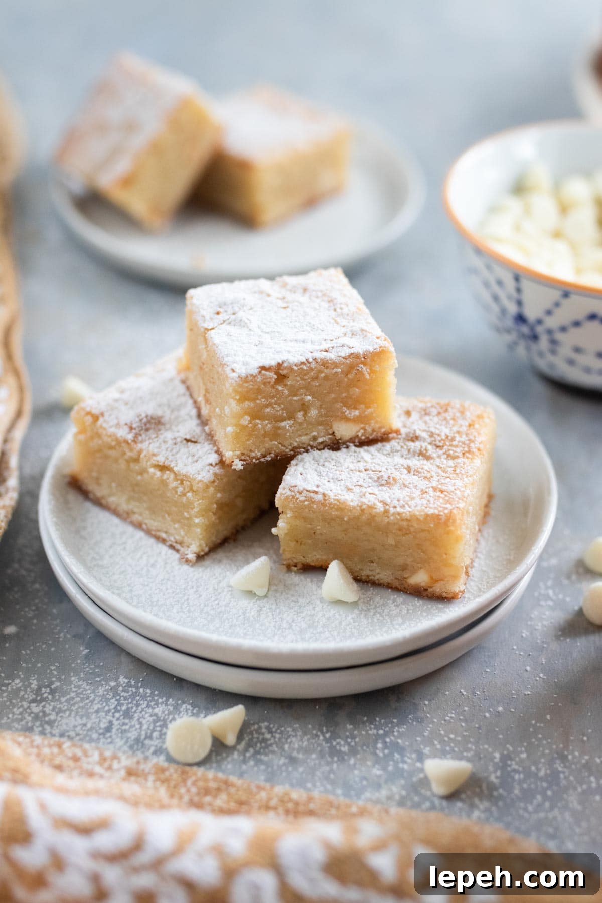 White brownie bars dusted with powdered sugar.