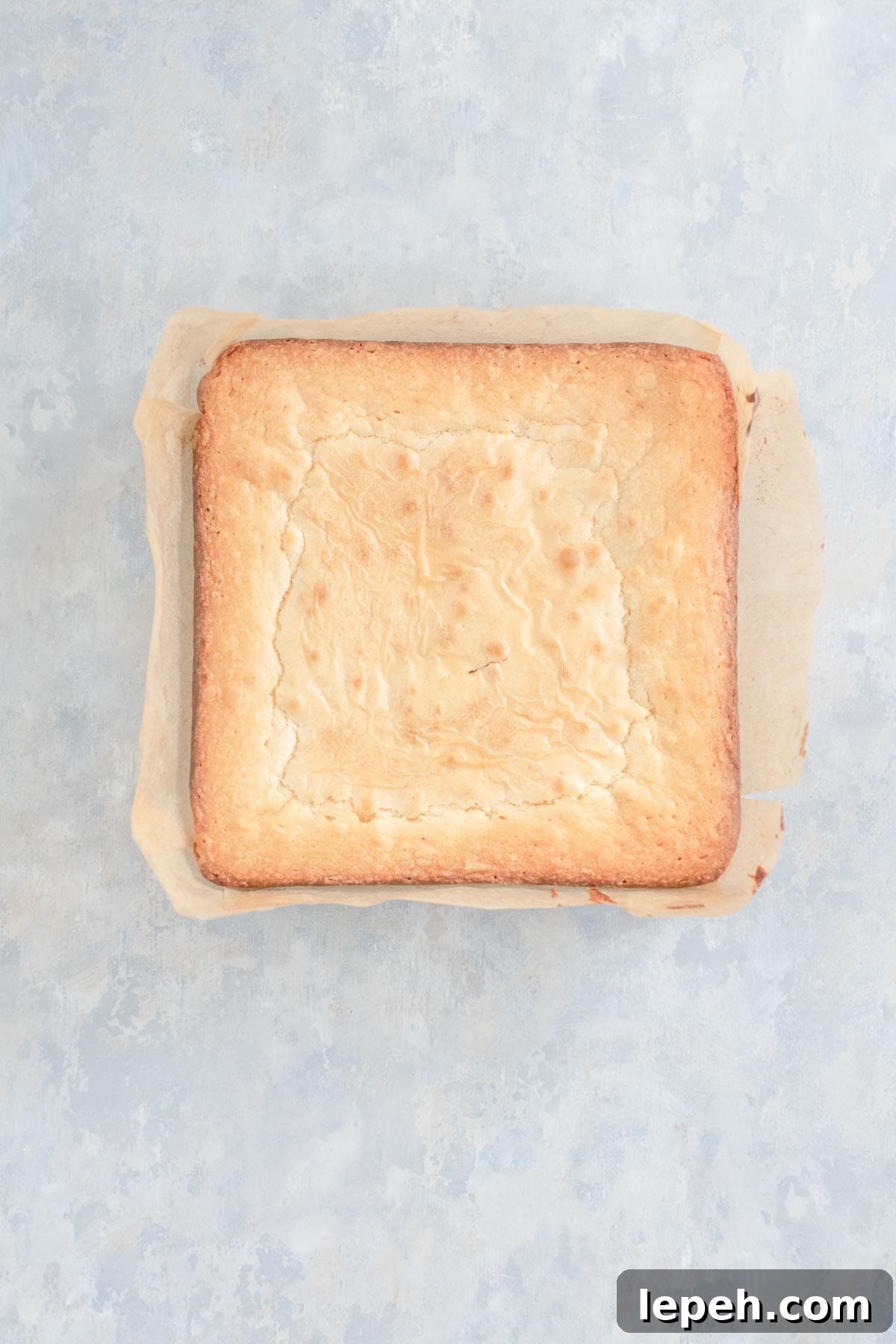 White brownies after baking, golden brown on the sides.