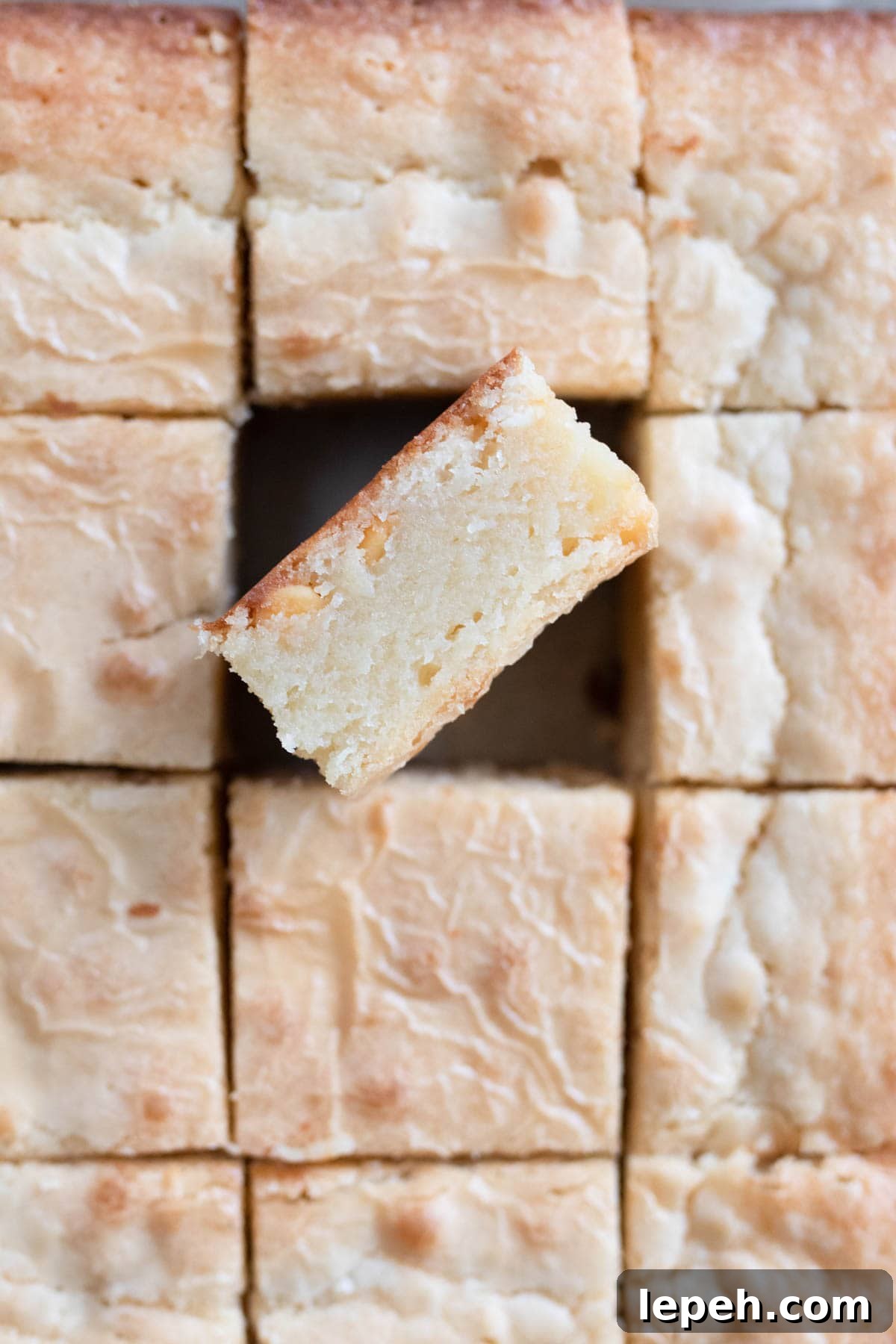 A white brownie on it's side in a baking pan.
