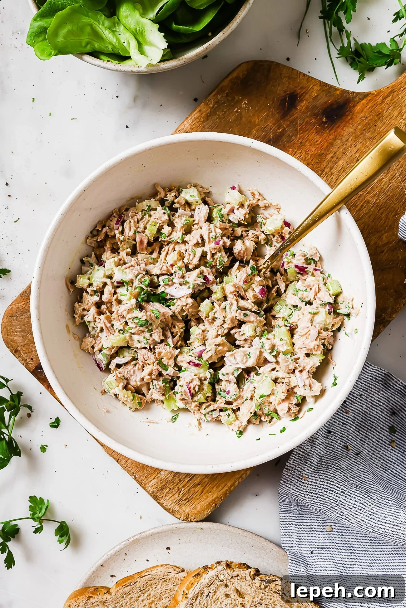 An overhead view of tuna salad in a white serving bowl.