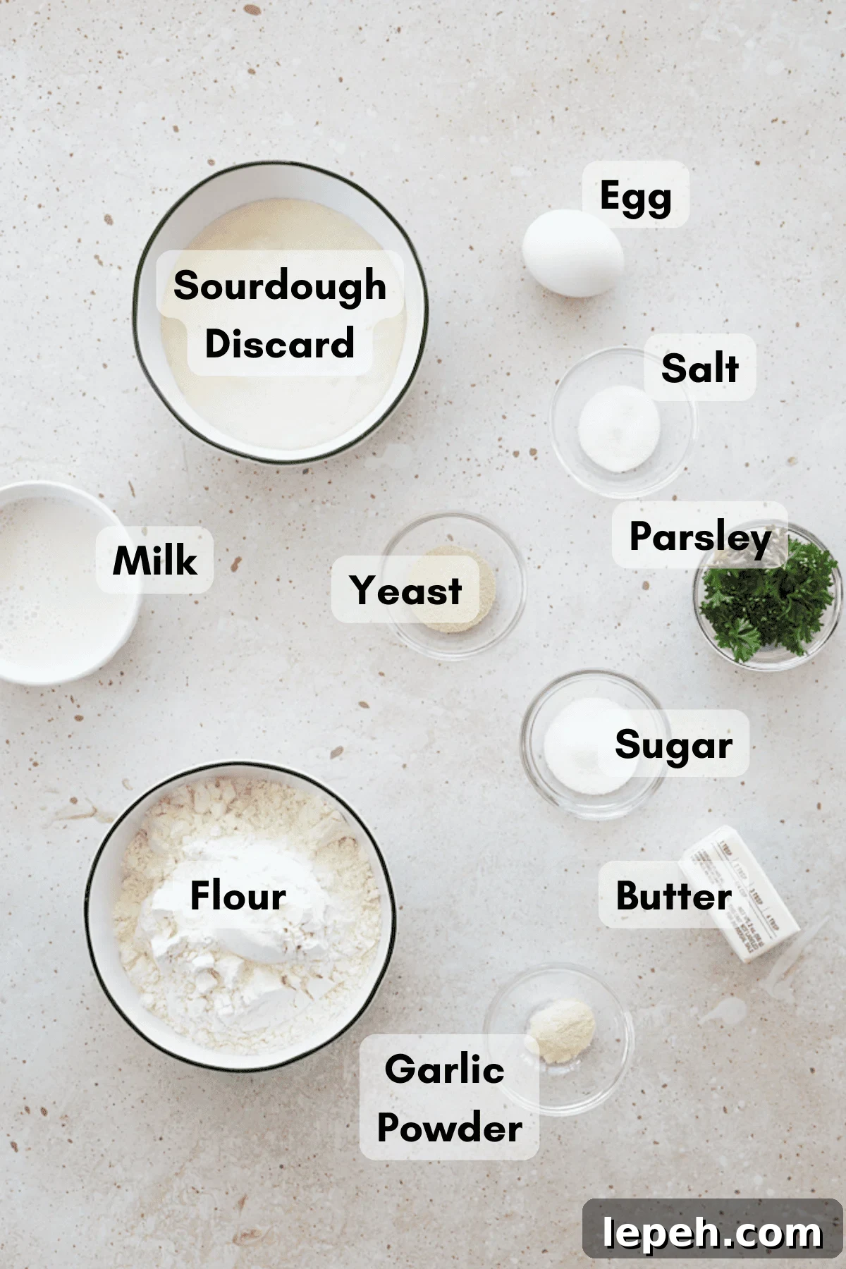 Ingredients for Sourdough Discard Garlic Rolls in small bowls. 