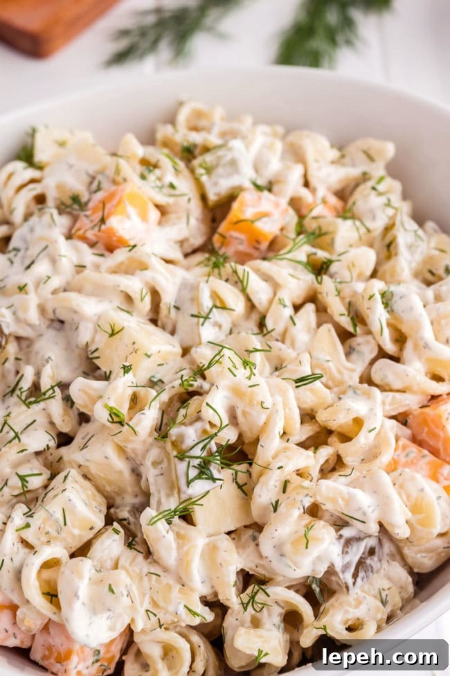 Pickle pasta salad in a white serving bowl