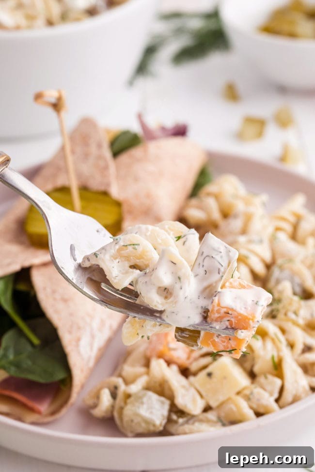 Dill pickle pasta salad on a fork