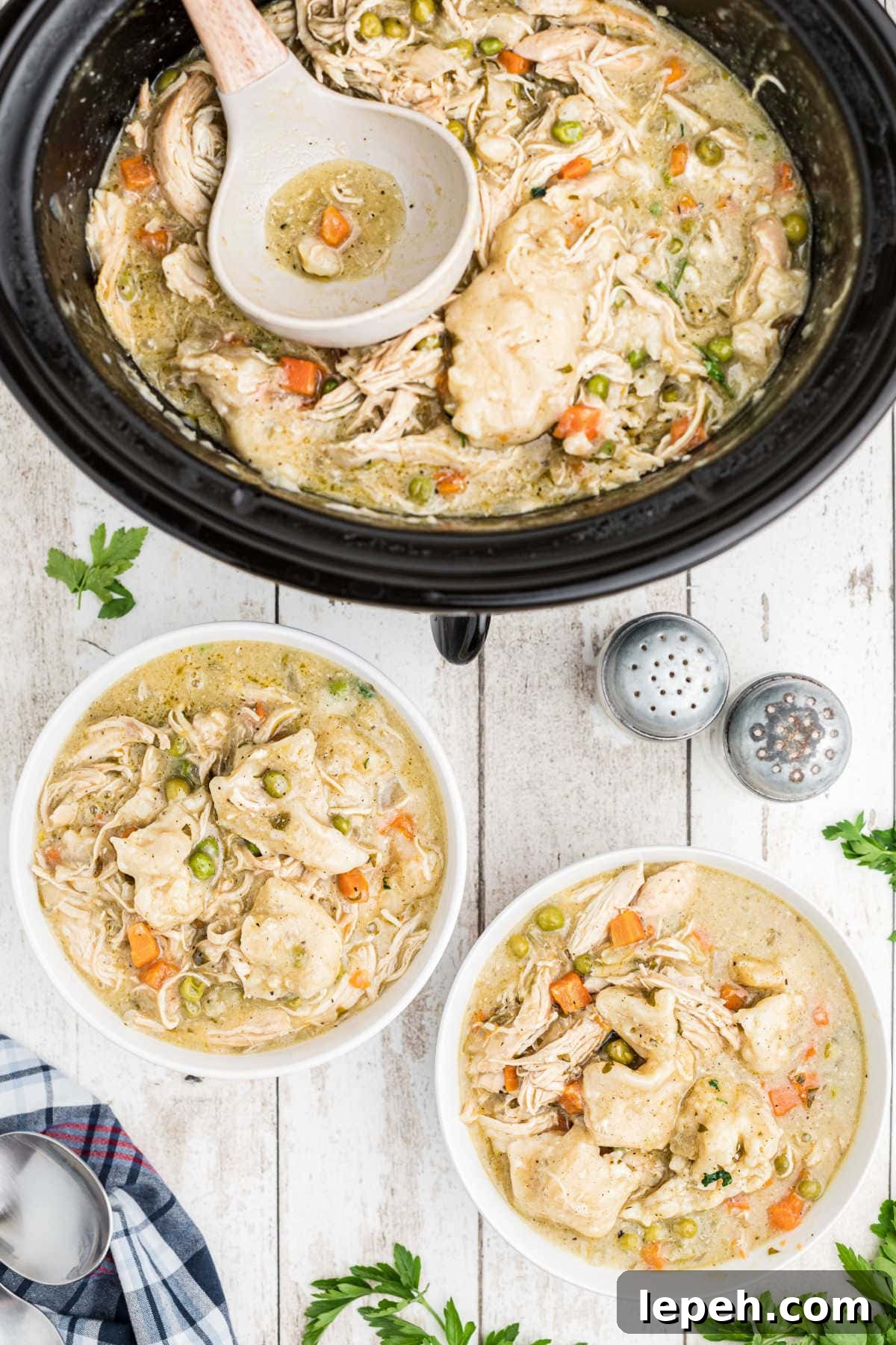 Two bowls filled with chicken and dumplings.
