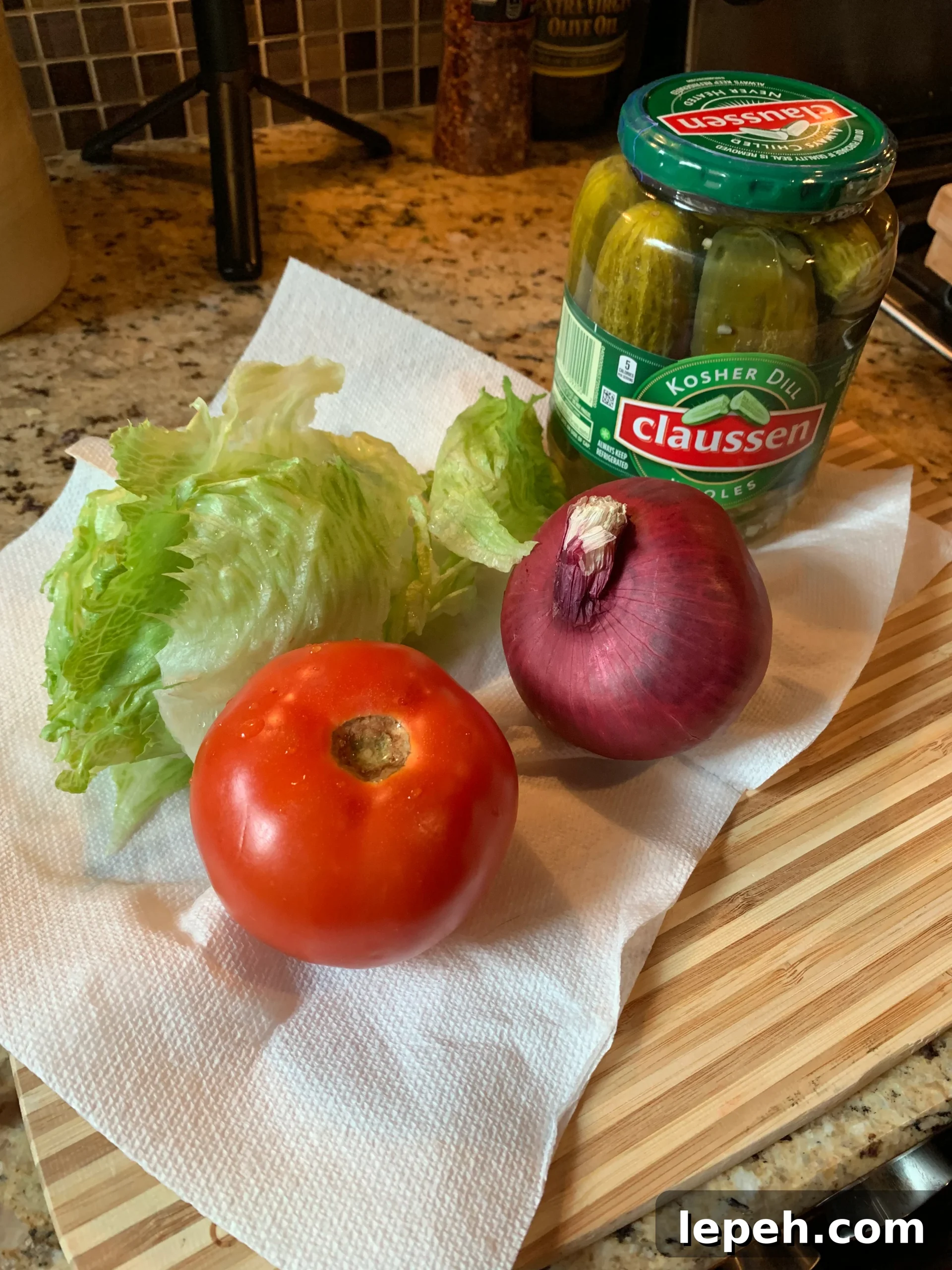 Tomato, lettuce, red onion, and pickles