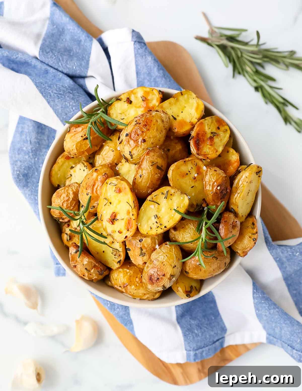 An overhead shot of roasted baby potatoes in a large bowl.