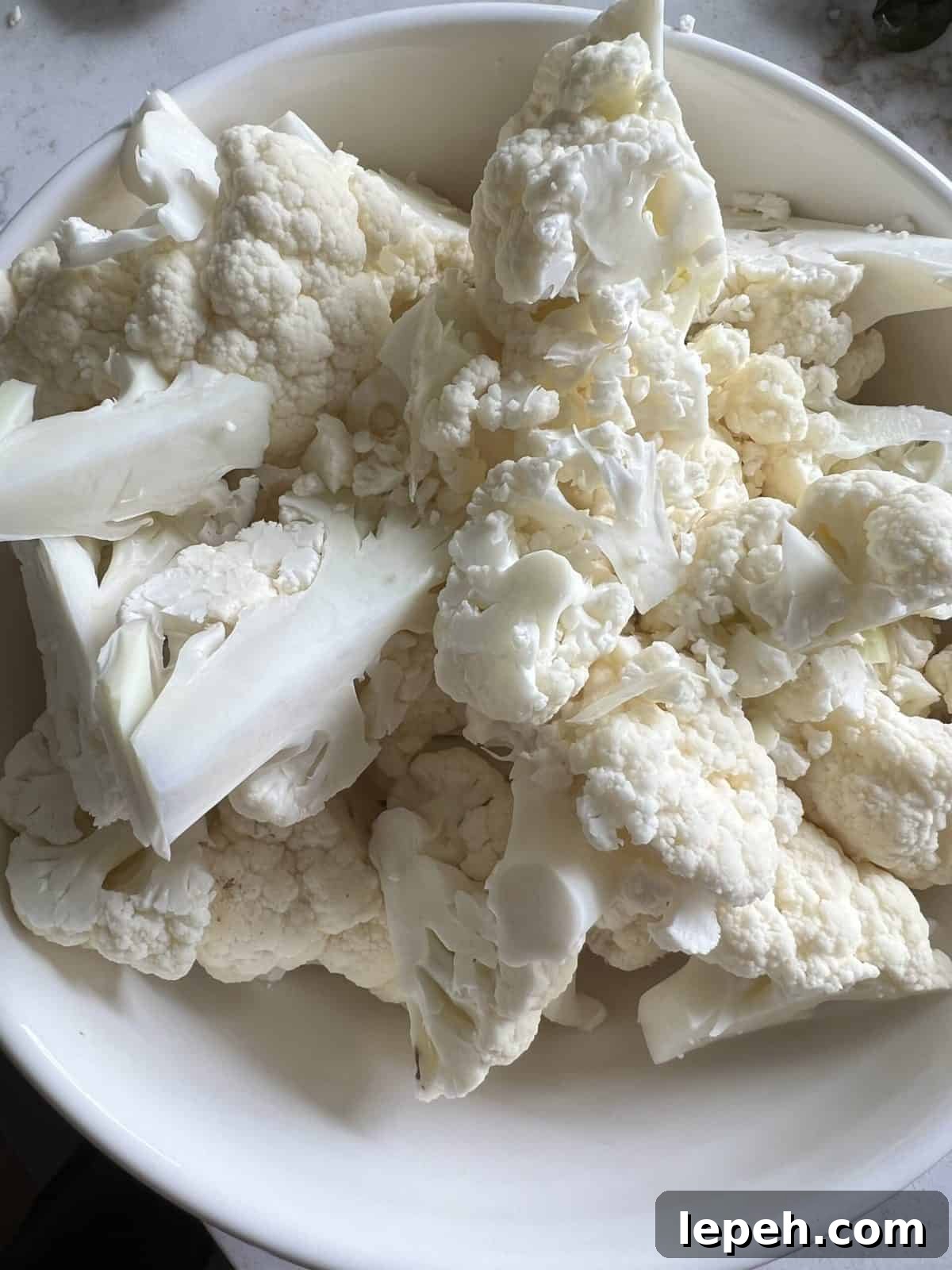 raw cauliflower in a white plate