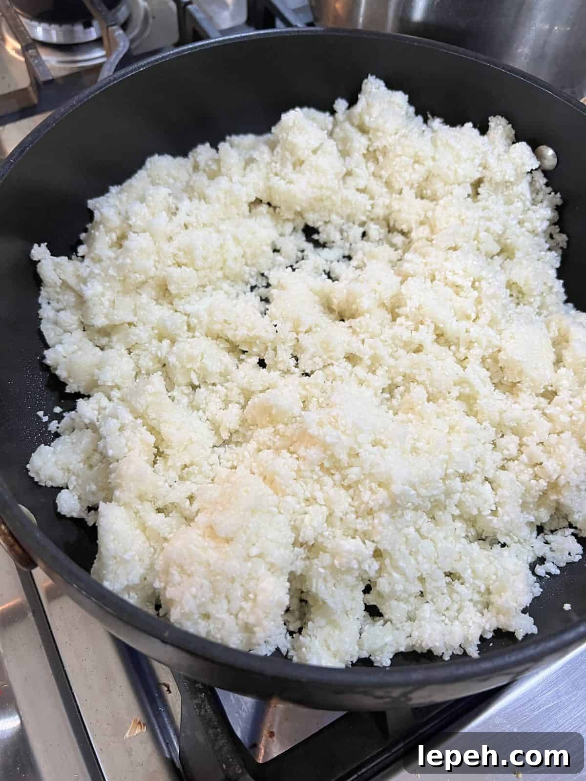 riced cauliflower in a black pan