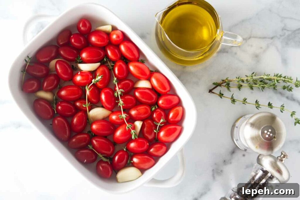 tomatoes in a dish, pitcher of olive oil, thyme sprigs, salt and pepper.