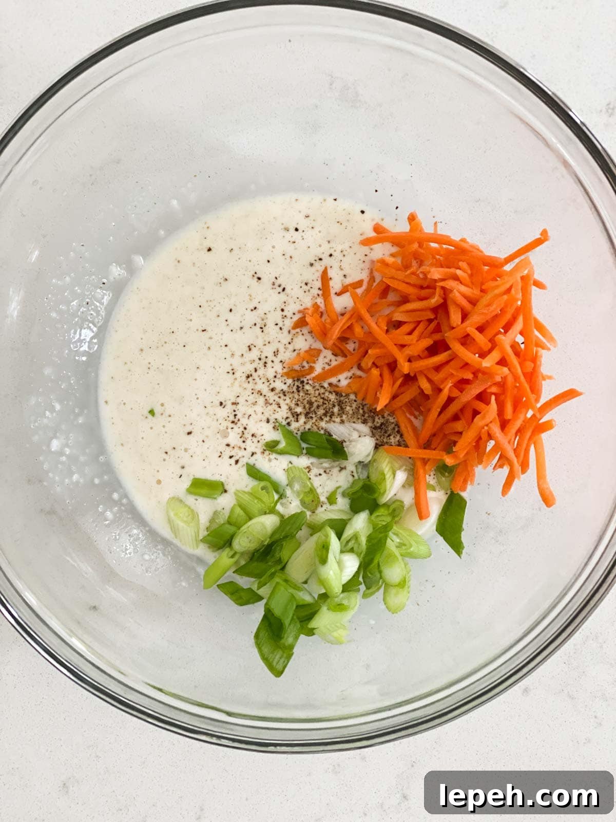 A bowl with ingredients for coleslaw