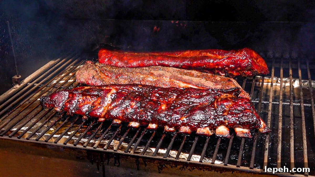 three racks of ribs on a smoker