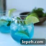 blue curaçao mojito in glass with lime
