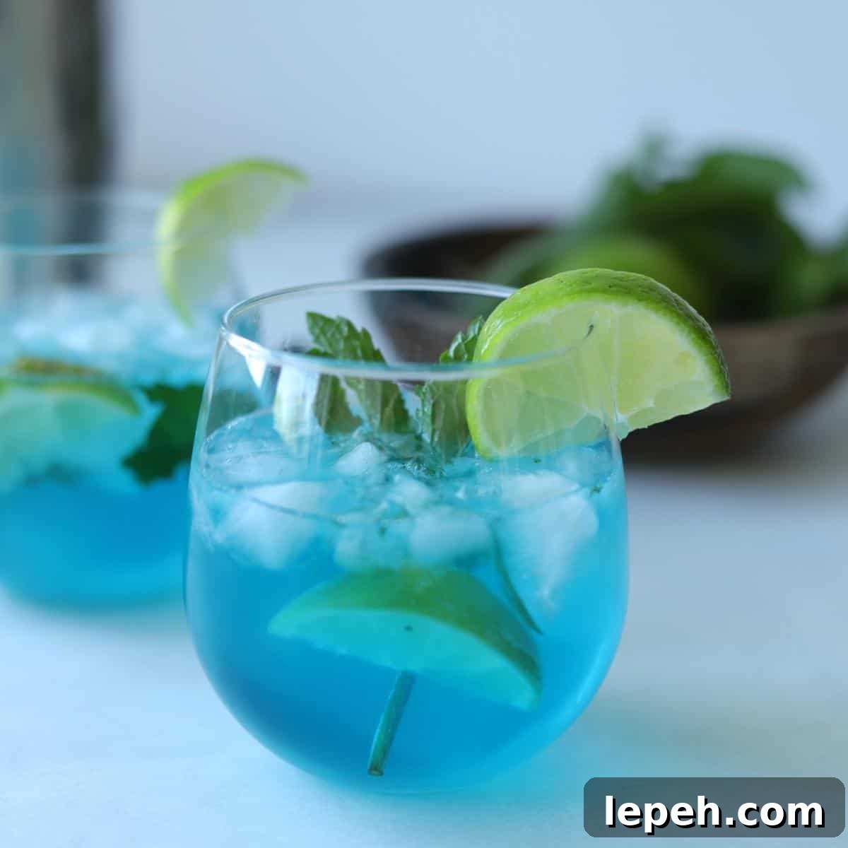 blue curaçao mojito in glass with lime