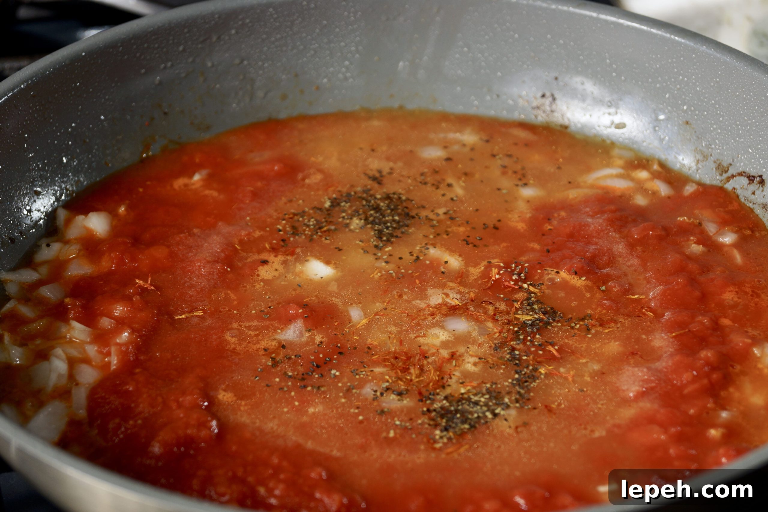 Crushed tomatoes and spices for Mexican cauliflower arroz con pollo