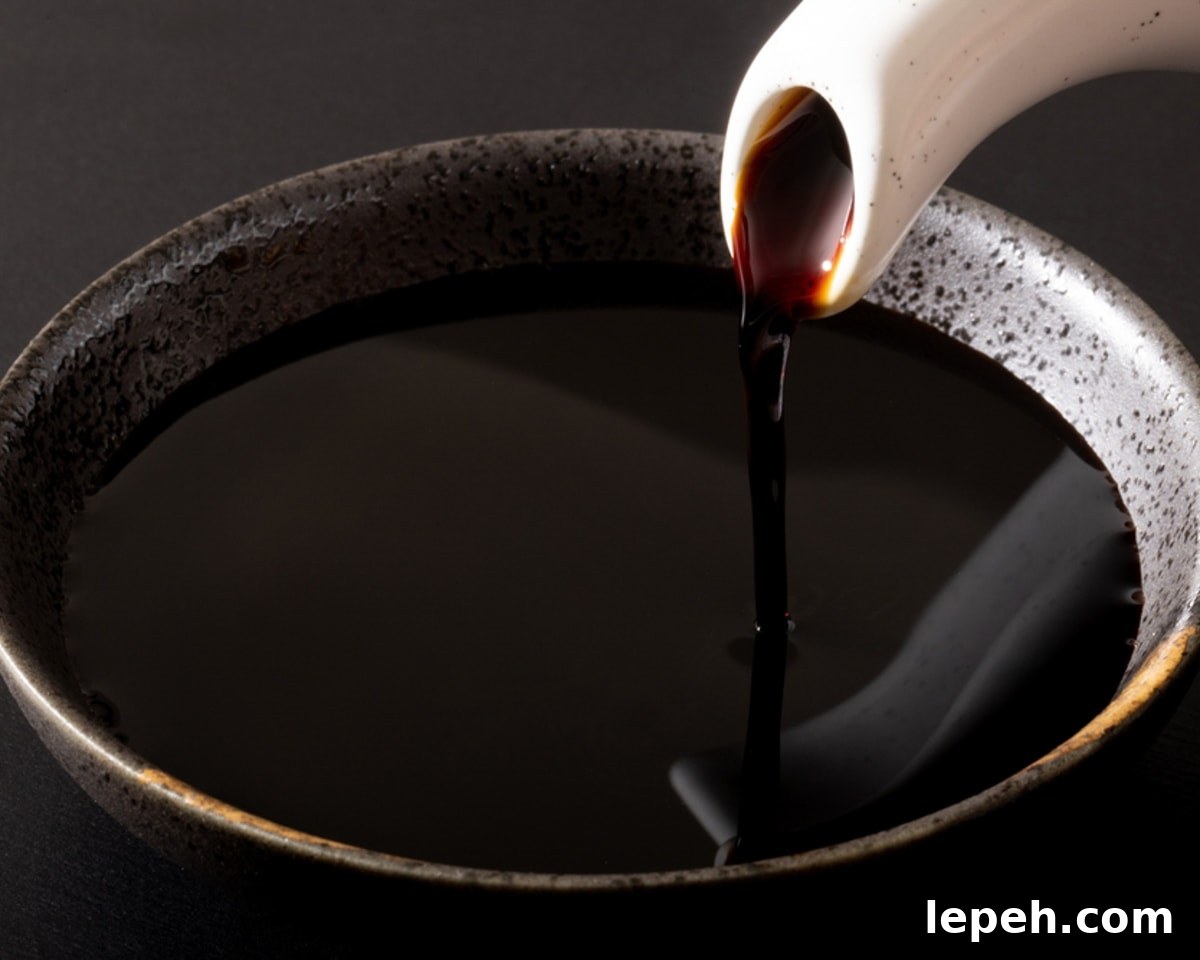 gravy boat pouring out tamari into a bowl.