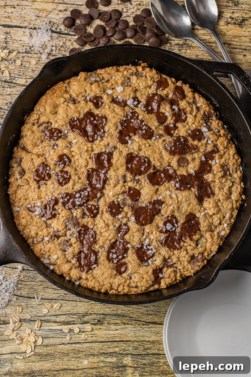 oatmeal skillet cookie with chocolate chips baked in a black cast iron skillet