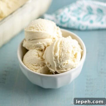 A bowl filled with scoops of homemade vanilla ice cream.