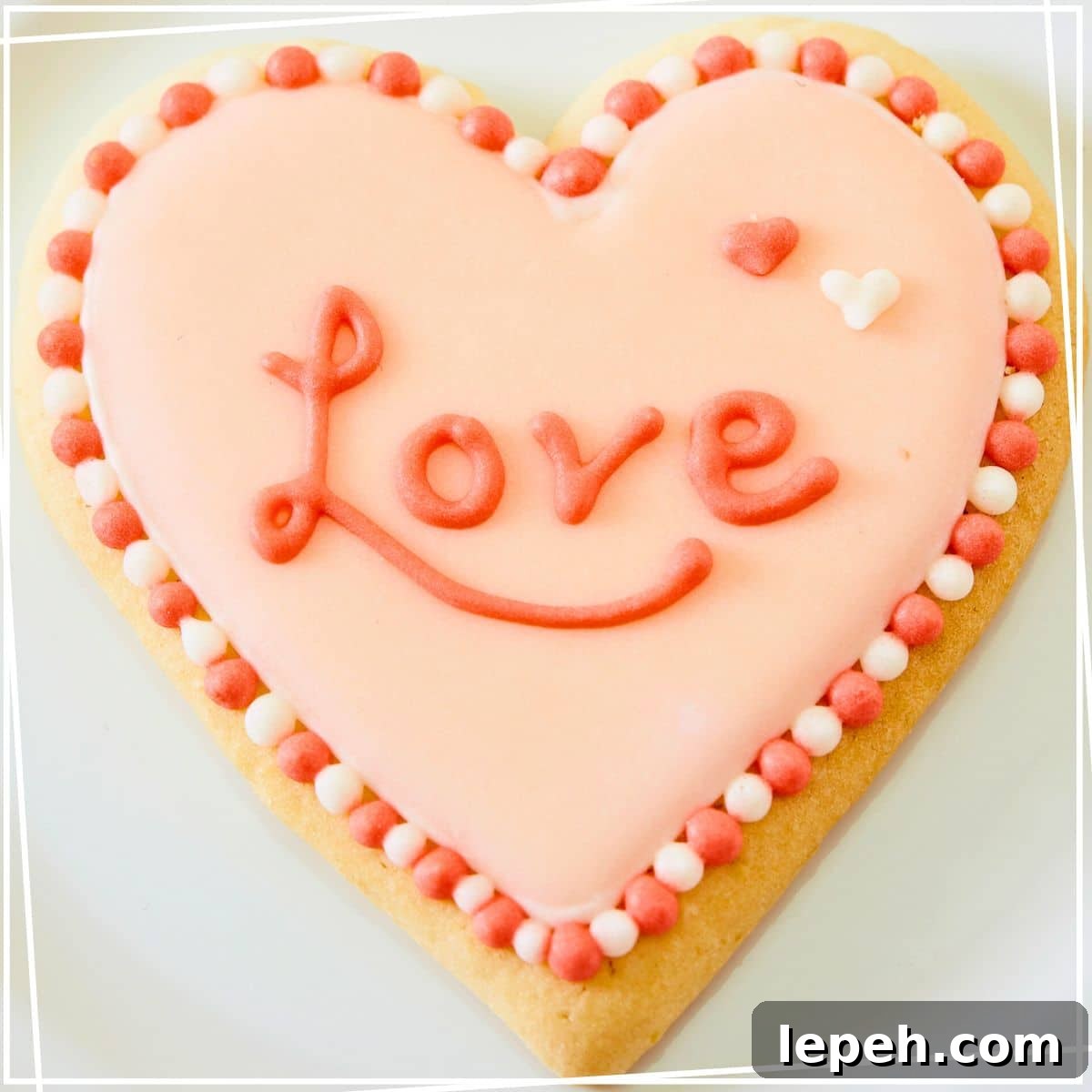 royal icing piping on heart sugar cookie